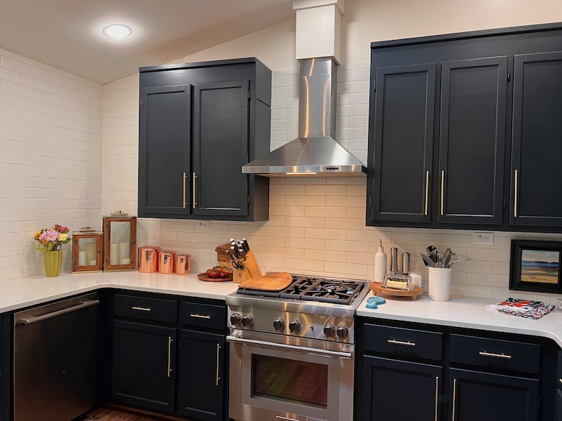 Navy blue kitchen with white subway tile