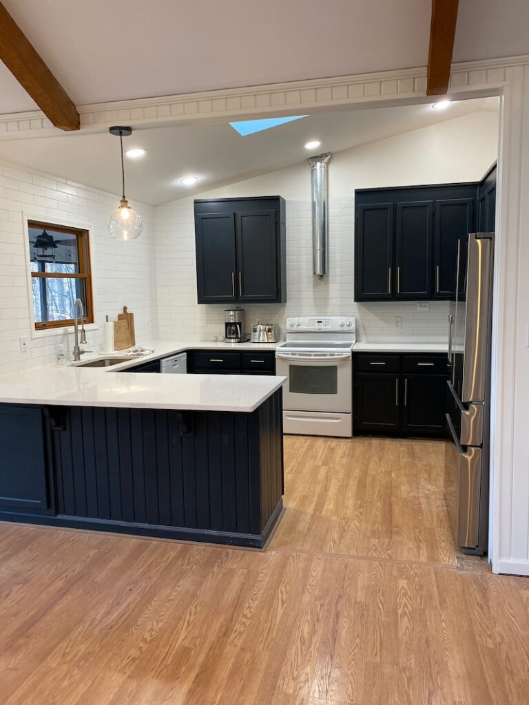 navy blue kitchen with white subway tile