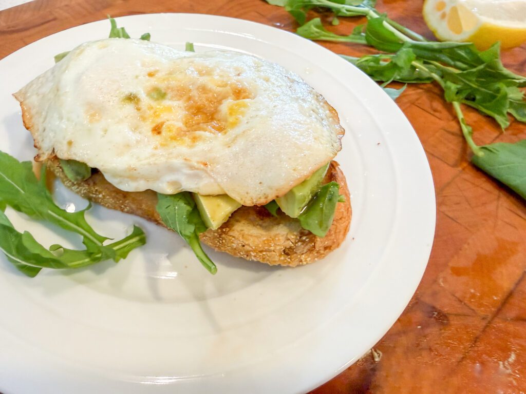 avocado toast with arugula and eggs