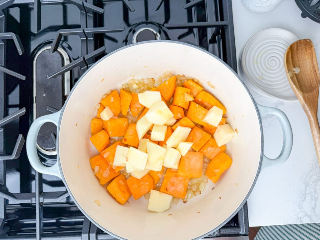 butternut squash and apples and onions sautéing for soup