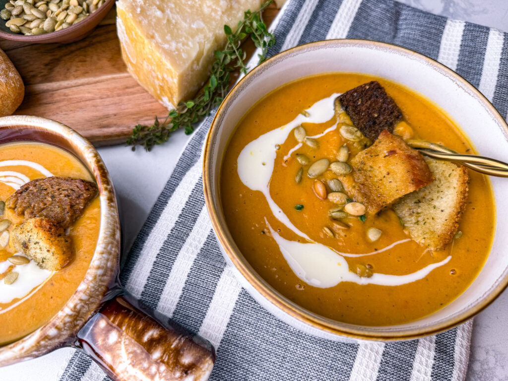 sweet potato and carrot soup with thyme, pepitas and cream